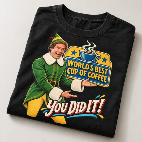 World's Best Cup of Coffee Elf Christmas T-Shirt, folded on a warm grey backdrop