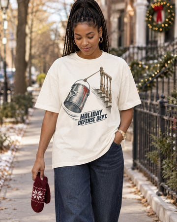 Holiday Defense Dept Paint Can Christmas T-Shirt, worn by a model