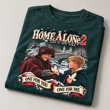 One for You One for Me Turtle Doves Christmas T-Shirt, folded on a warm grey backdrop