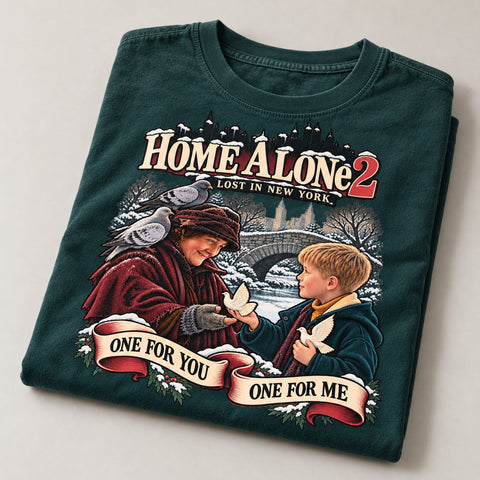 One for You One for Me Turtle Doves Christmas T-Shirt, folded on a warm grey backdrop