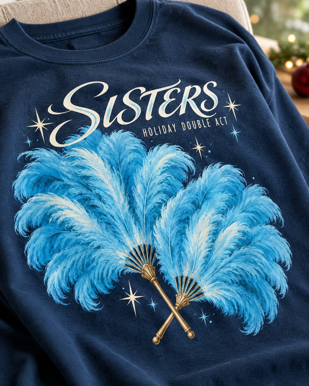 Sisters Holiday Double Act Feather Fan T-Shirt, close-up of the print