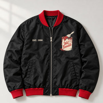 Black bomber jacket with red ribbing and a Wet Bandits paint can print