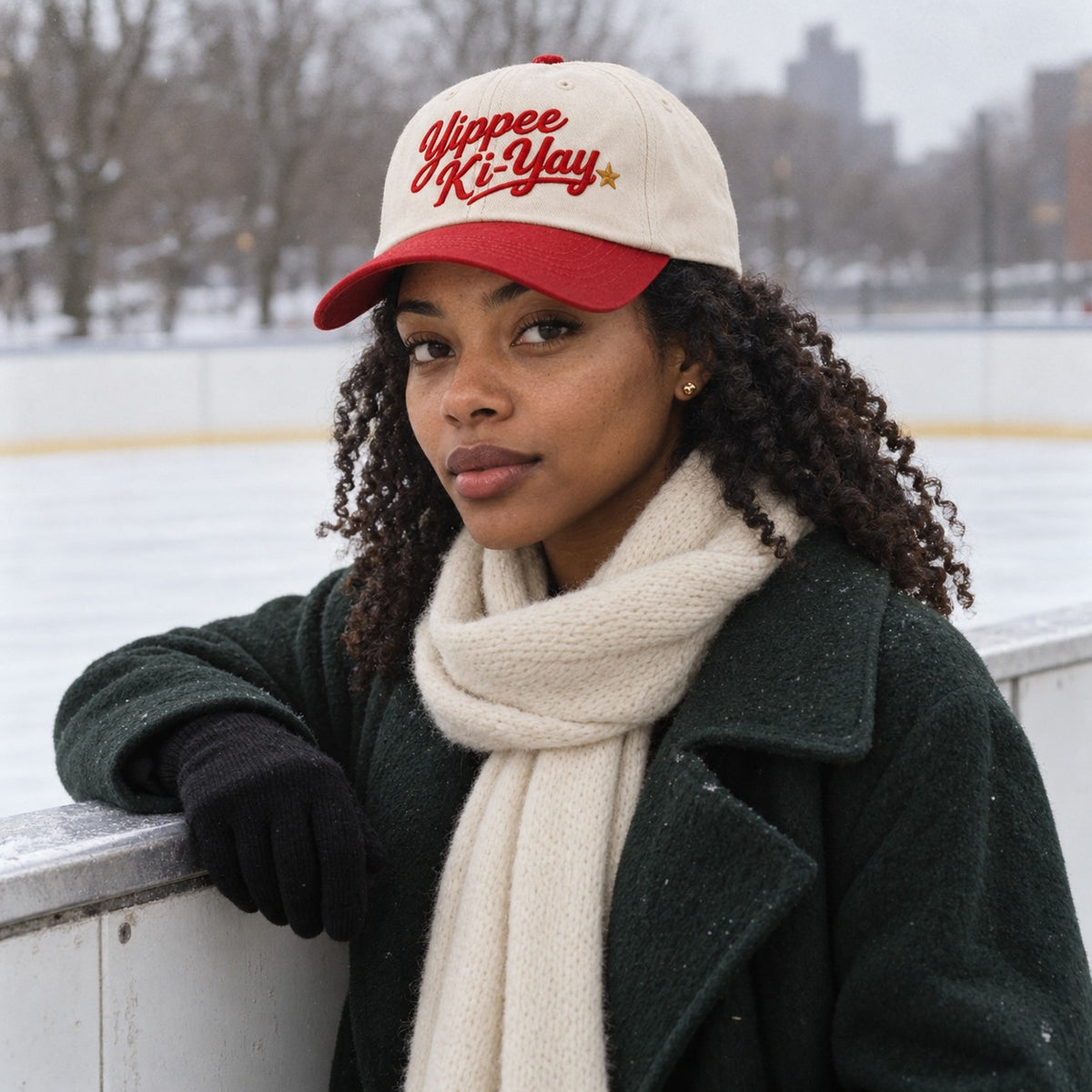 Woman wearing the Yippee Ki-Yay embroidered cap at an outdoor ice rink