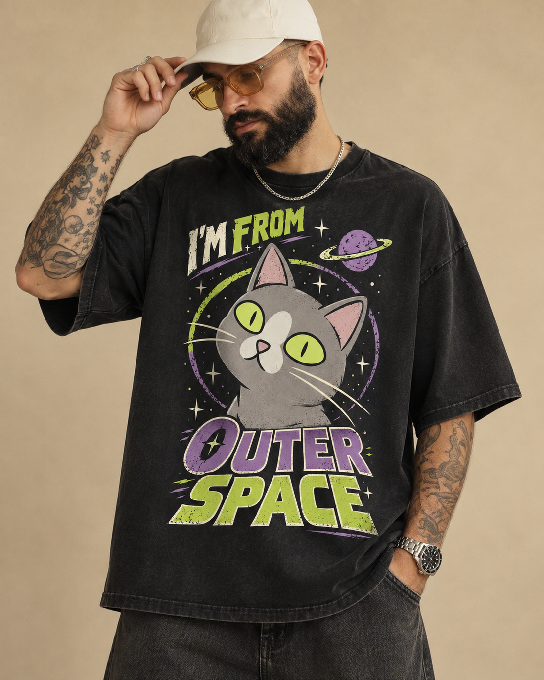 Mockup of a black Outer Space Cat graphic T-shirt with retro lettering and cream, lime and purple cat artwork.